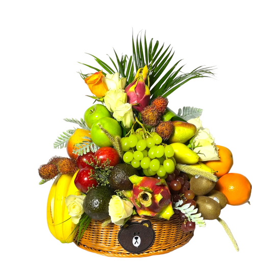 Fruit and flower arrangement in a woven basket on a white background