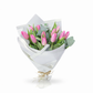 Bouquet of pink tulips wrapped in white paper on a white background