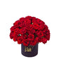 Bouquet of red roses in a black box with 'Blue Flowers & Gifts' branding on a light gray background.
