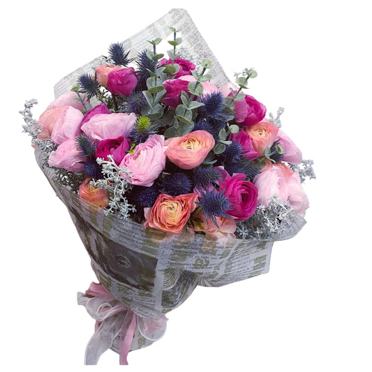 Bouquet of pink and purple flowers wrapped in newspaper with a visible brand logo.
