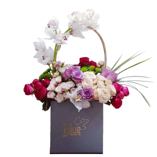 Floral arrangement in a box with a visible brand logo on a white background